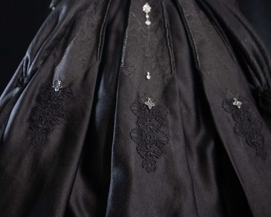 Black satin skirt with lace appliqué