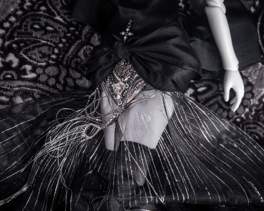 Black feathered skirt detail