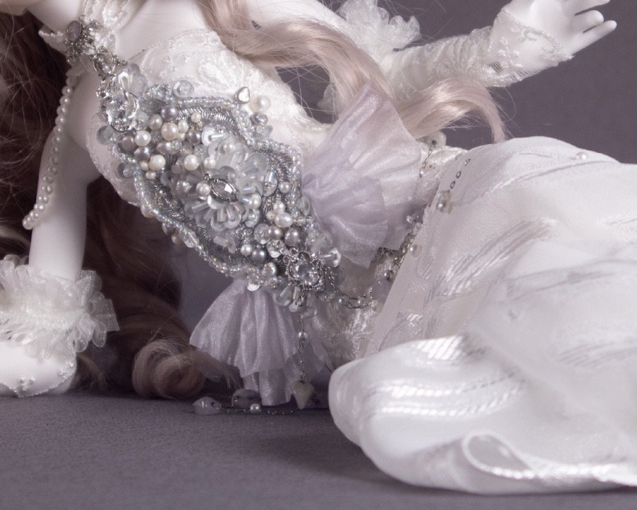 Ivory gown with pearl embroidery, reclining
